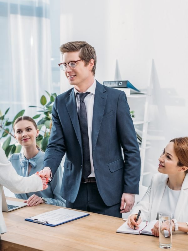 cheerful-man-in-glasses-shaking-hands-with-recruiter-on-job-interview.jpg